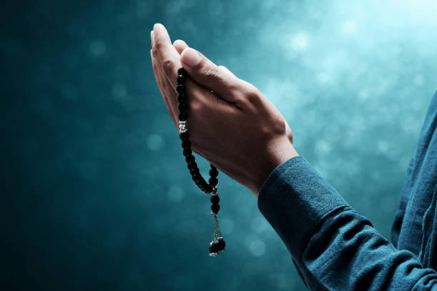 istock Muslim man praying with rosary beads 1388152469