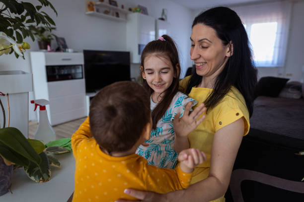 istock Smiling woman with children 1388152492