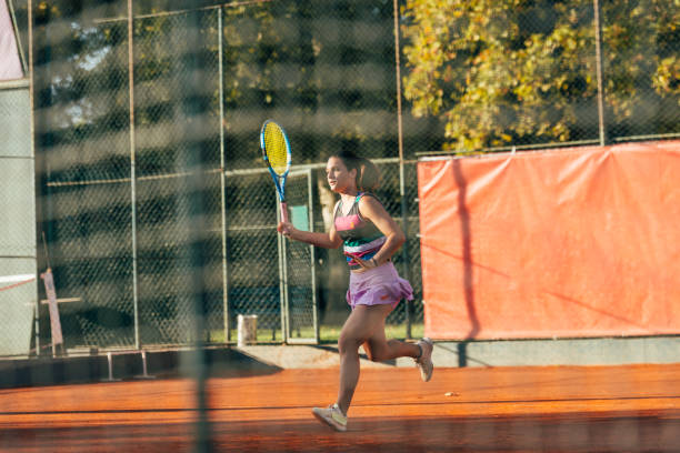 istock Pretty female tennis player observed through the net. 1388152602