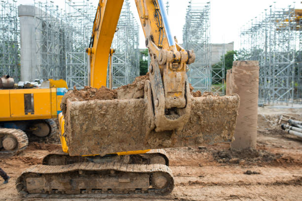 istock A large yellow excavator with a front bucket is picking up earth at a construction site 1388152862