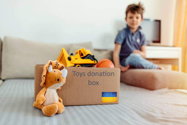 istock Boy with donation box for Ukraine kids. 1388154505