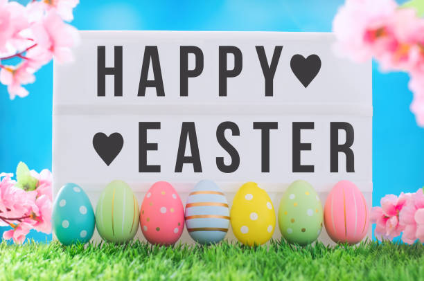 istock Happy Easter text On light box against bright blue sky and flowers. 1388155126