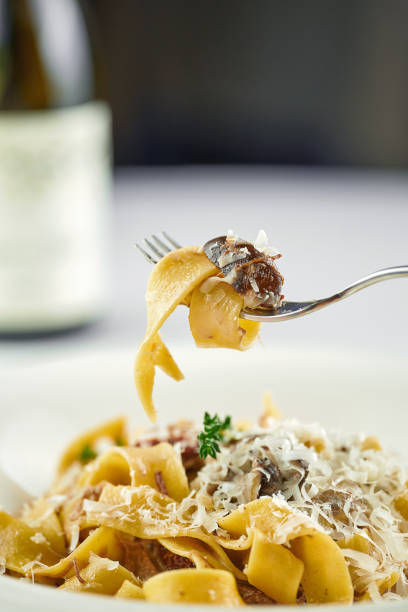 istock Tagliatelle with parmesan twisted on a fork. Selective focus, shallow depth of field 1388155952