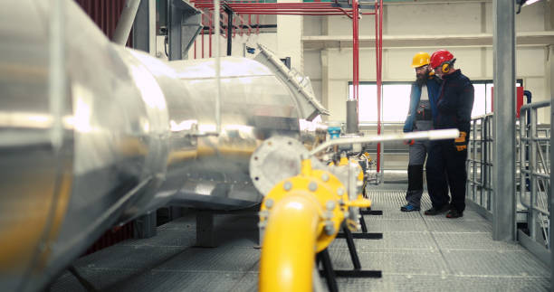 istock Power plant workers repair machines during working hours. 1388156413