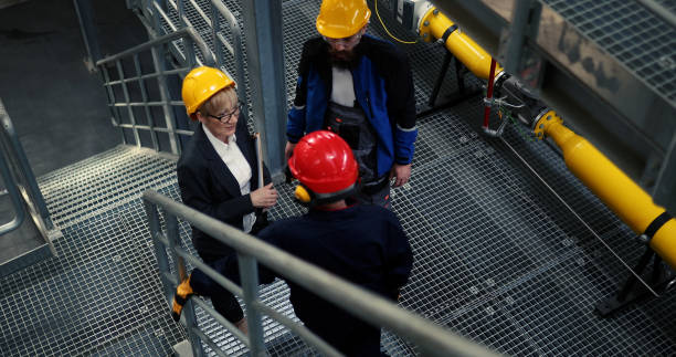 istock A businesswoman talks to power plant workers about the heating system. 1388156416
