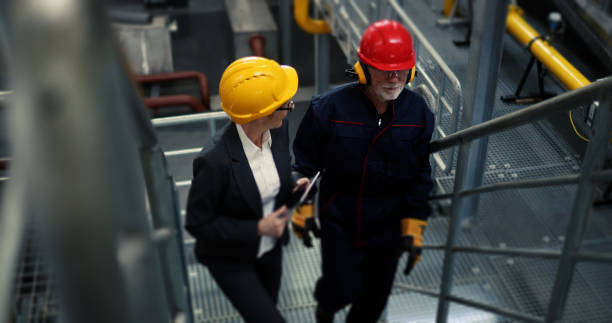 istock While talking about work, the supervisor and the worker climb to the first floor. 1388156419