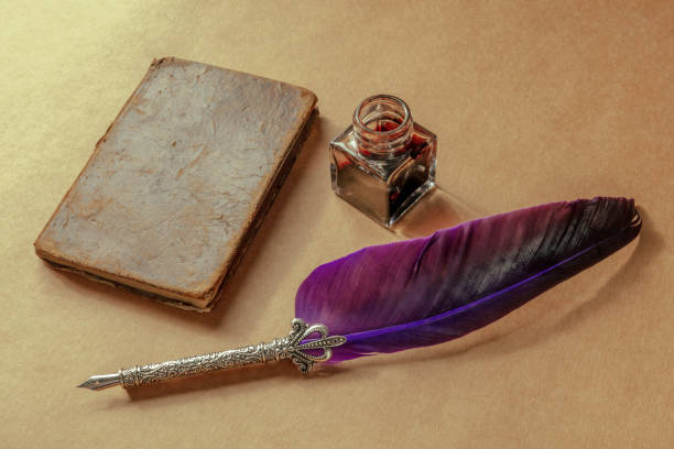 istock A quill pen, a vintage ink well, and an old notebook, retro objects 1388159064