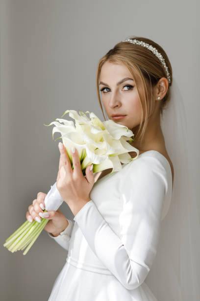 istock The bride is holding a bouquet in her hands 1388159504