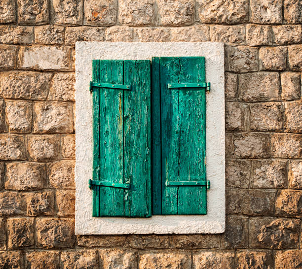 istock Old sash green windows in a stone house. 1388161836