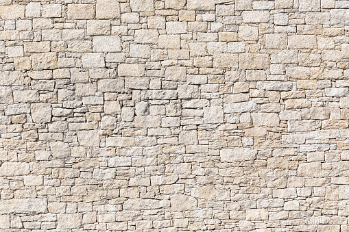 Granite Stone wall background texture. Dry masonry wall