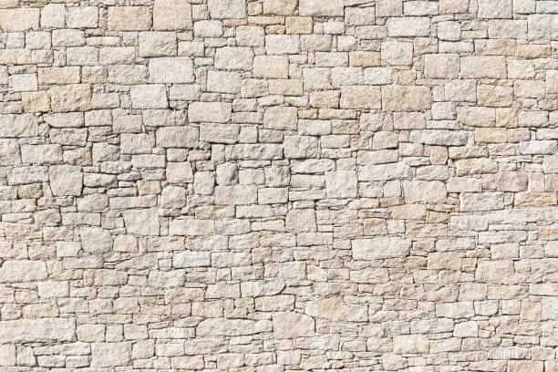 Granite Stone wall background texture. Dry masonry wall