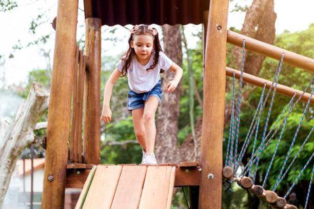 istock Little girl playing in a public park. 1388166119