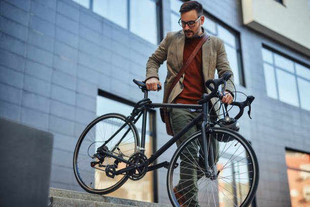 istock Businessman going home from work by bike 1388166398