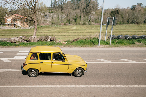 Old yellow car on a road