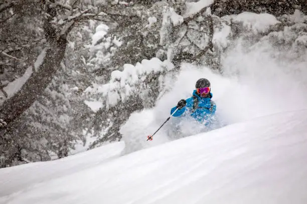Freeride skier riding in heavy snowing day in back country terrains