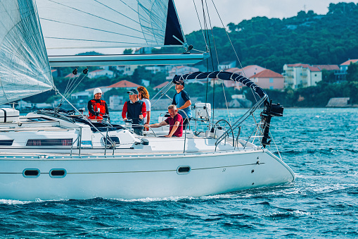 Sailing crew on sailboat during regatta