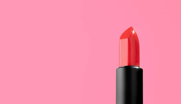 istock A bright red lipstick in a black matt case on a pink background. Decorative cosmetics on a bright pink background. Facial cosmetic, fashion, makeup. From view, minimalistic, copy space 1388169925