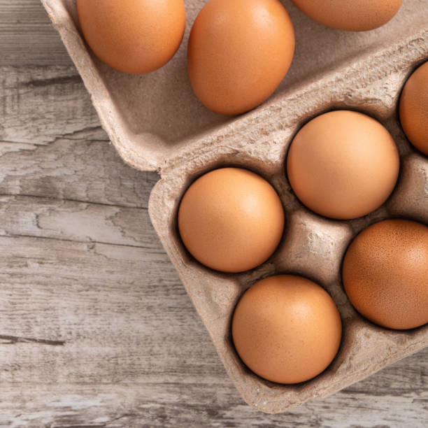 istock Fresh brown chicken eggs in a kraft paper egg carton. 1388171658