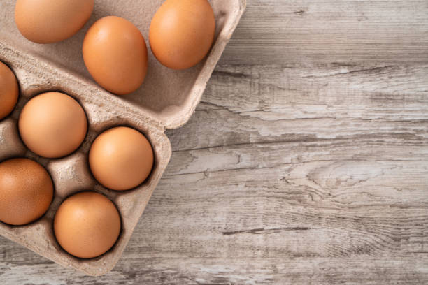 istock Fresh brown chicken eggs in a kraft paper egg carton. 1388171983