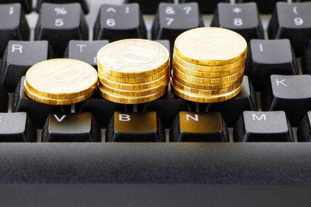 Gold coins and black keyboard. Work at home. Make maoney.Select focus. Freelance concept.