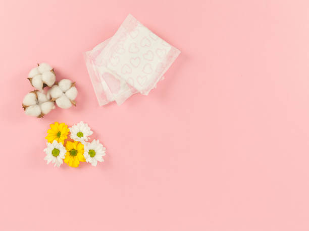 istock woman pad and flowers on pink background 1388174520