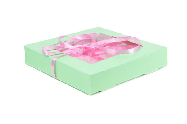 istock Gigt light green box with pink ribbon isolated on a white background. Gift box 1388176029