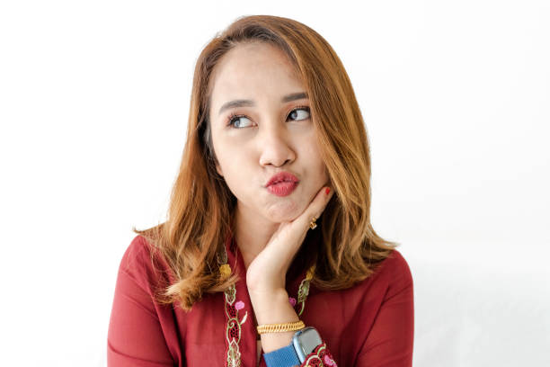 A portrait shot of asian female wearing kebaya or traditional dress for Raya celebration with isolated white background,
