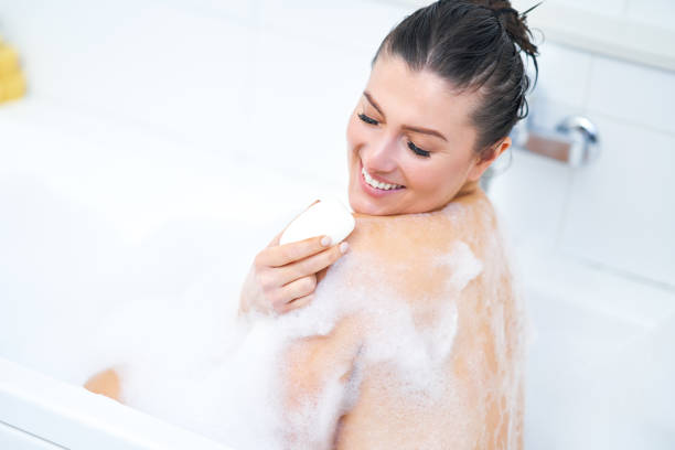 istock Young nice brunette woman having bath in bathtub 1388177056