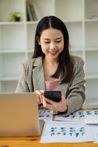 istock A business analyst or accountant calculates and examines financial documents. Asian businesswoman making calculations Concept of saving, finance and economy via laptop. 1388178201