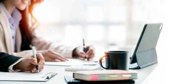 istock Professional business team working together at desk. 1388178754