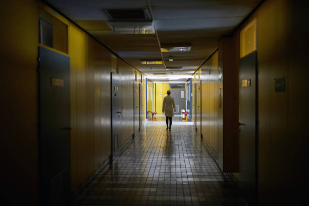 istock An institution employee walking a hallway. Institution, hallway, university 1388180139