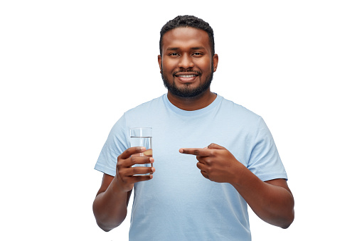 healthy eating, diet and people concept - happy smiling african american man showing glass of water over white background