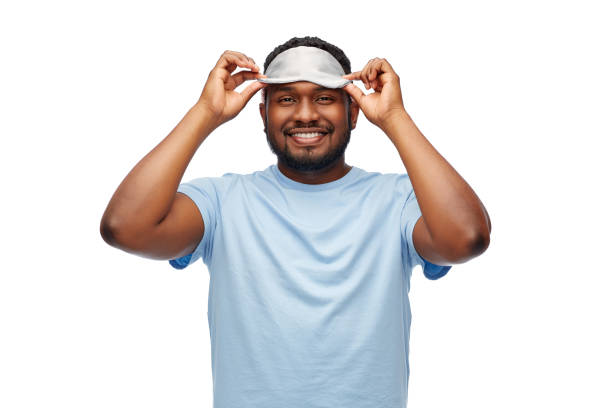 istock happy african american man with eye sleeping mask 1388181765