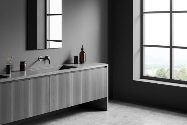 istock Grey bathroom interior with sink and mirror near window 1388184913