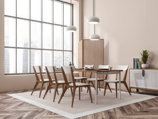 istock Light dining interior with seats, drawer and table near panoramic window 1388184922
