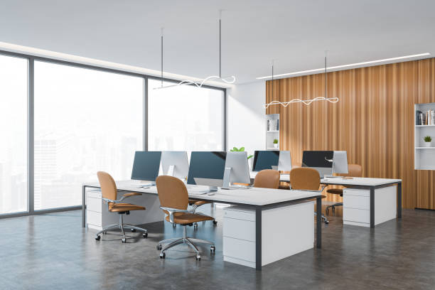 istock Corner view on bright office interior with desk with desktop 1388186074