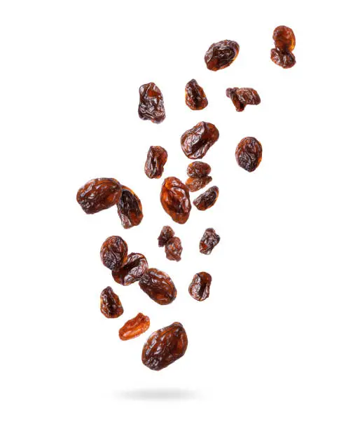 Photo of Delicious raisins in the air, isolated on a white background