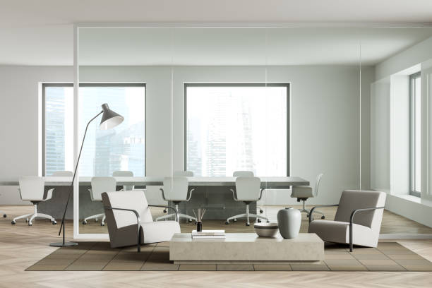 istock Business interior with relaxing zone with chairs, conference area and window 1388186702