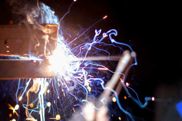 istock welder working on a metal structure fixing an urgent problem on the night shift close-up, front and back background blurred with bokeh effect 1388187102