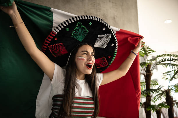 Teenage Latin girl celebrating Mexico soccer team win stock photo