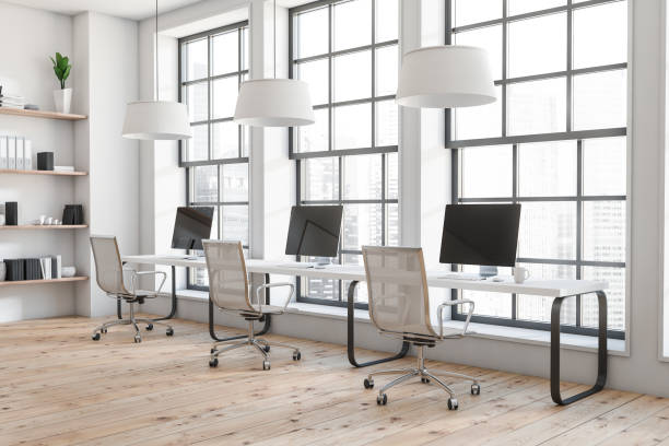 istock Business room interior with seats, table with desktop, window with city view 1388187929