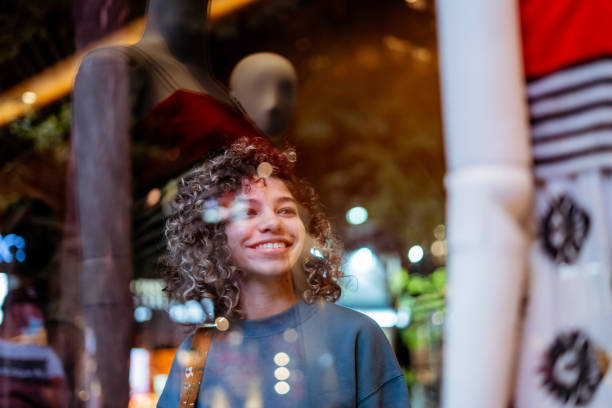 istock Young woman looking at clothing store 1388189021