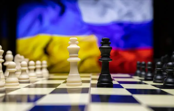 War between Russia and Ukraine, conceptual image of war using chess board, pieces and national flags on the background. Ukrainian & Russian crisis, political conflict. Stop the war 2022