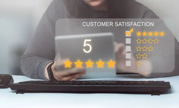 Photo of Woman rating a service on digital tablet.