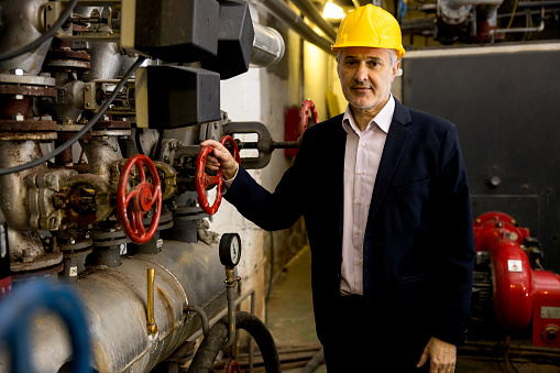 Senior engineer working in factory at the night