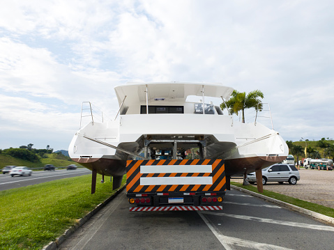 Photo of a truck transporting a large boat.
