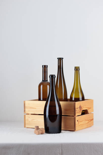 istock Green wine bottles in the box on the white table 1388190517