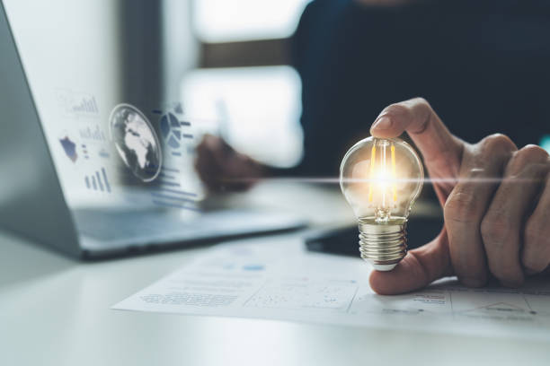 istock Glowing light bulb with graph and data. Business success idea concept 1388191535