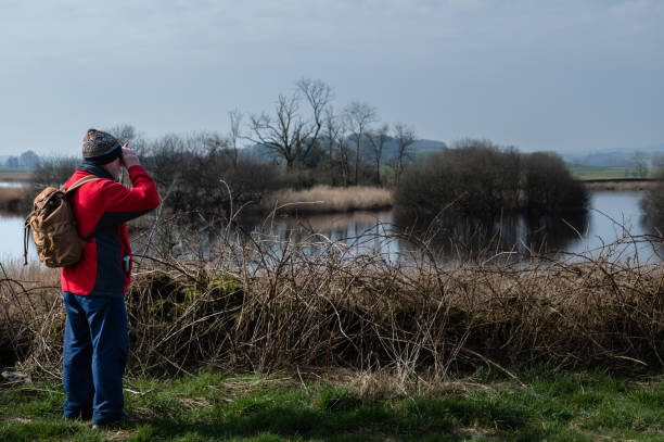 istock Senior man standing beside a river in a rural area 1388191980
