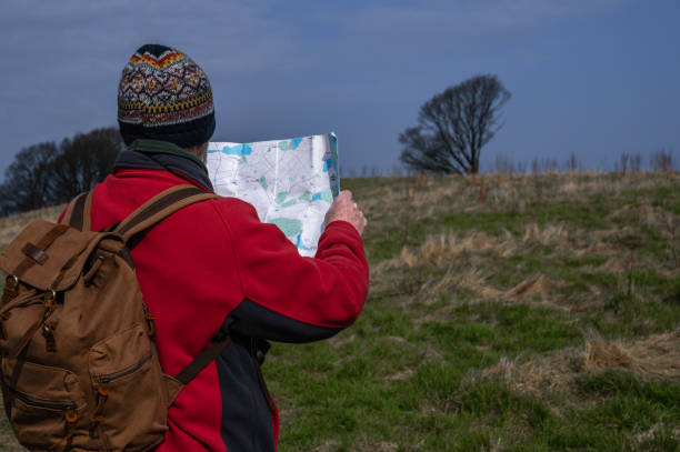 istock Retired man in a rural location checking his map 1388192742